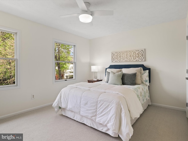 bedroom featuring ceiling fan, carpet, and baseboards