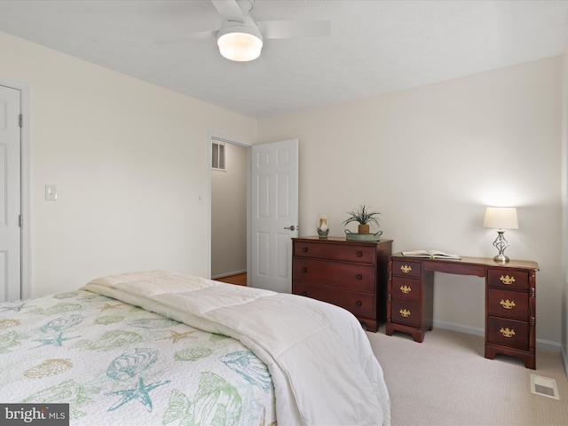 bedroom featuring baseboards, visible vents, a ceiling fan, and light carpet