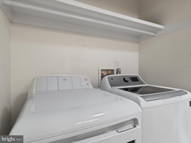 washroom with washing machine and clothes dryer and laundry area
