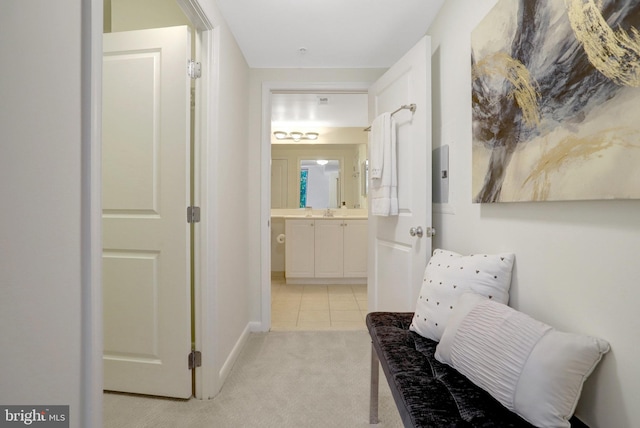 851 N Glebe Rd Unit 321, Arlington, VA 22203 - hall with a sink, light tile patterned floors, baseboards, and light carpet