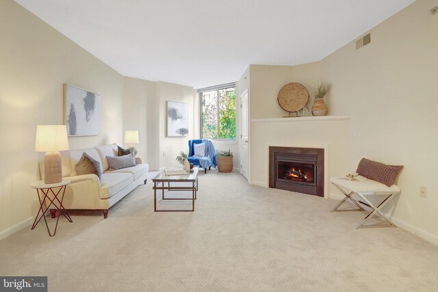 851 N Glebe Rd Unit 321, Arlington, VA 22203 - living room with visible vents, carpet, baseboards, and a warm lit fireplace