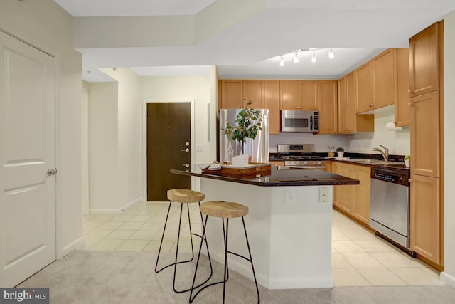 851 N Glebe Rd Unit 321, Arlington, VA 22203 - kitchen with light tile patterned floors, a kitchen island, a breakfast bar area, and stainless steel appliances