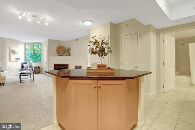 851 N Glebe Rd Unit 321, Arlington, VA 22203 - kitchen featuring a center island, baseboards, a fireplace, and open floor plan
