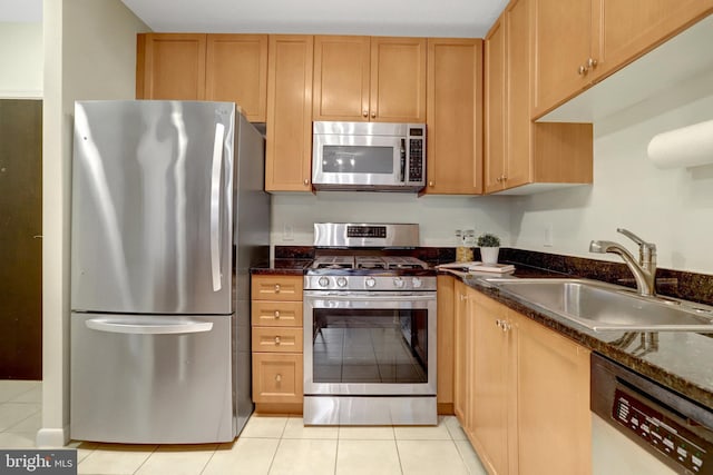 851 N Glebe Rd Unit 321, Arlington, VA 22203 - kitchen with dark stone counters, light tile patterned flooring, appliances with stainless steel finishes, and a sink