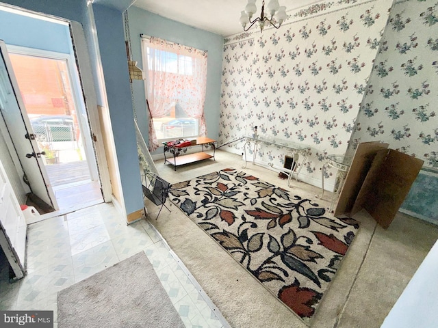interior space featuring a chandelier, baseboards, and wallpapered walls