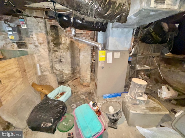 utility room featuring heating unit