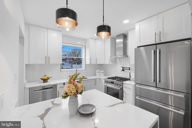 133 Ingraham St NW, Washington, DC 20011 - kitchen with tasteful backsplash, wall chimney range hood, white cabinets, and appliances with stainless steel finishes