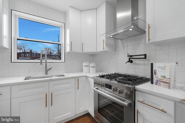 133 Ingraham St NW, Washington, DC 20011 - kitchen featuring a sink, wall chimney exhaust hood, stainless steel range, and white cabinets
