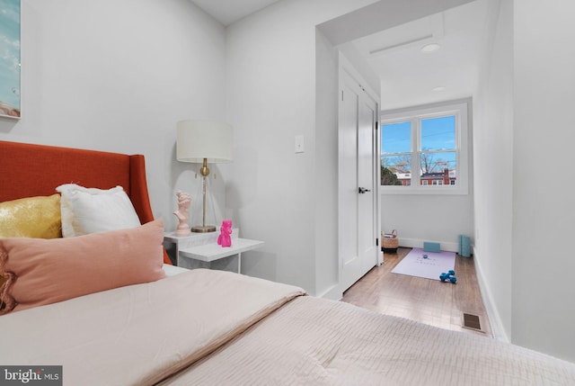 133 Ingraham St NW, Washington, DC 20011 - bedroom with visible vents, baseboards, attic access, and wood finished floors