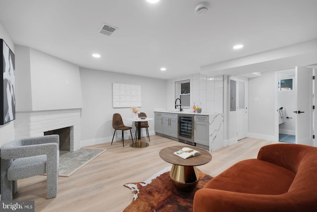 133 Ingraham St NW, Washington, DC 20011 - living room with baseboards, wet bar, light wood-style flooring, visible vents, and beverage cooler