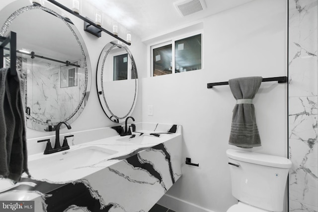 133 Ingraham St NW, Washington, DC 20011 - bathroom with visible vents, a marble finish shower, a sink, and toilet