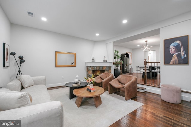 133 Ingraham St NW, Washington, DC 20011 - living area with wood finished floors, a stone fireplace, visible vents, and recessed lighting