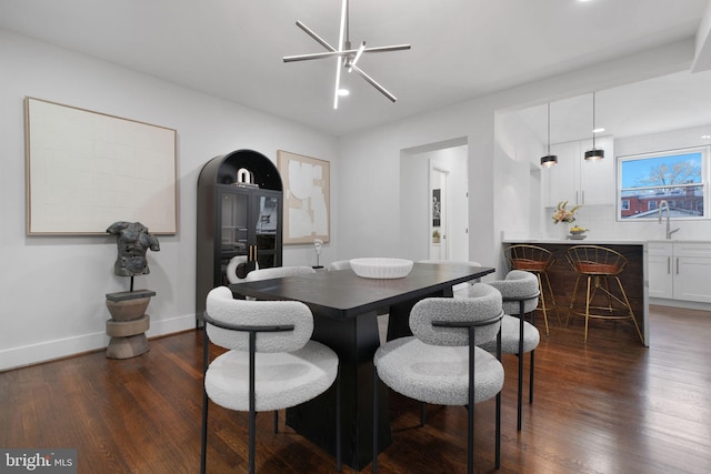 133 Ingraham St NW, Washington, DC 20011 - dining area with dark wood-type flooring, a bar, and baseboards