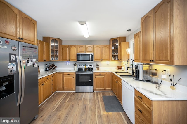 522 White Oak Rd, Fredericksburg, VA 22405 - kitchen with light wood-type flooring, glass insert cabinets, light countertops, stainless steel appliances, and a sink