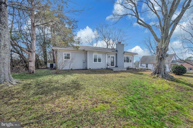 522 White Oak Rd, Fredericksburg, VA 22405 - rear view of house with cooling unit, a lawn, and a chimney