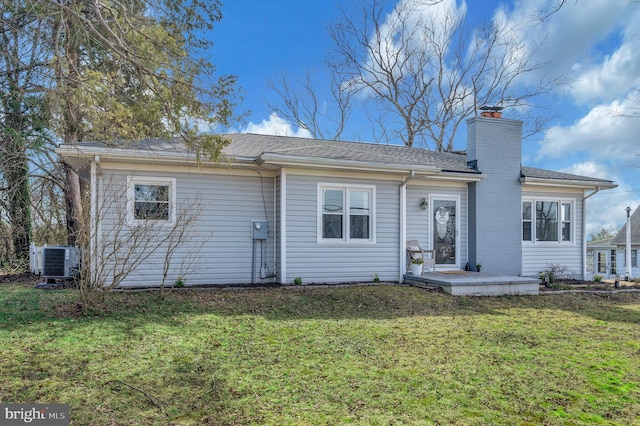 522 White Oak Rd, Fredericksburg, VA 22405 - back of property featuring central AC, a lawn, and a chimney