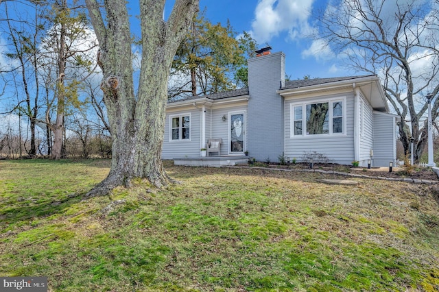 522 White Oak Rd, Fredericksburg, VA 22405 - back of house with a chimney and a lawn
