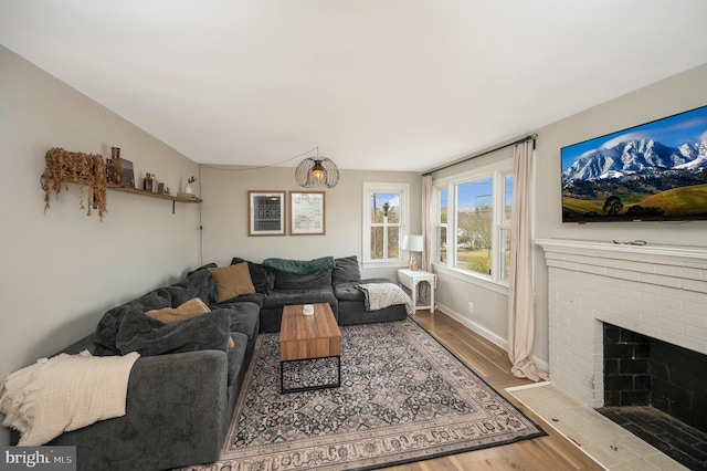 522 White Oak Rd, Fredericksburg, VA 22405 - living room featuring wood finished floors, a fireplace, and baseboards
