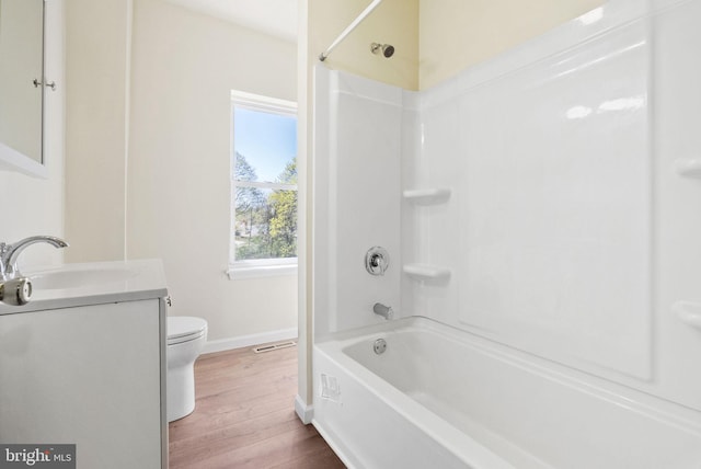 full bathroom featuring toilet, baseboards, shower / washtub combination, wood finished floors, and vanity