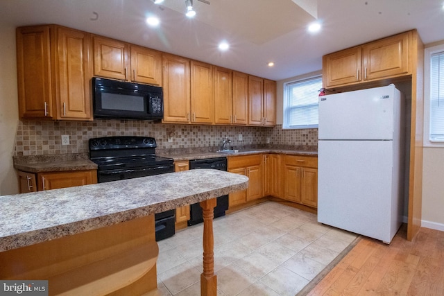 7834 Fayette St, Philadelphia, PA 19150 - kitchen with light wood-style flooring, a sink, recessed lighting, backsplash, and black appliances
