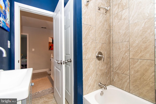 bathroom with visible vents and shower / tub combination