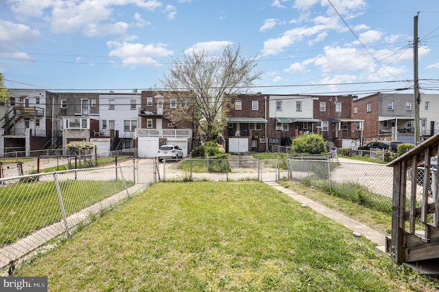 view of yard featuring fence and a residential view