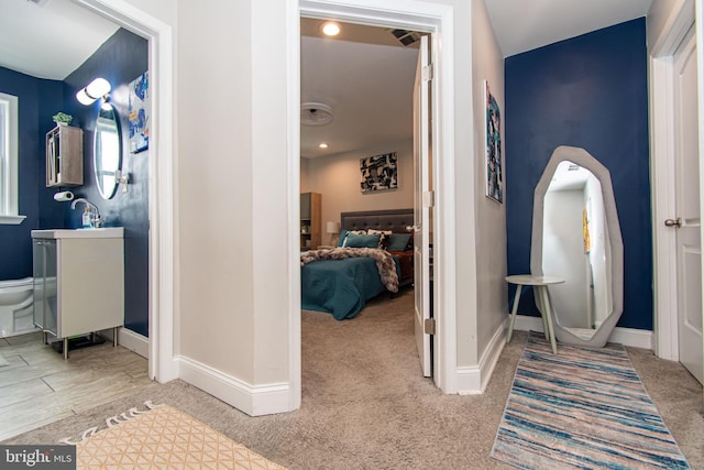 hall featuring carpet floors and baseboards