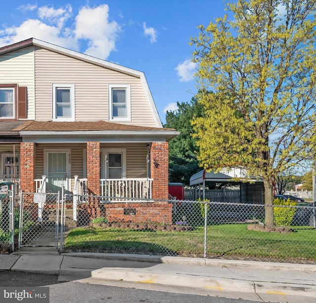 4125 Saint Thomas Ave, Baltimore, MD 21206 - view of front facade with a gate, a gambrel roof, a fenced front yard, a porch, and brick siding