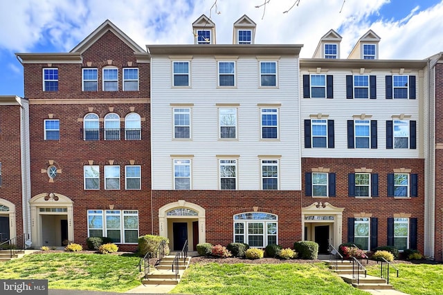 view of property featuring brick siding