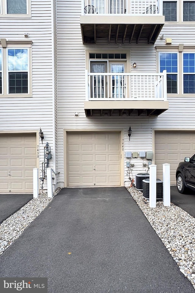 exterior space featuring central air condition unit and aphalt driveway