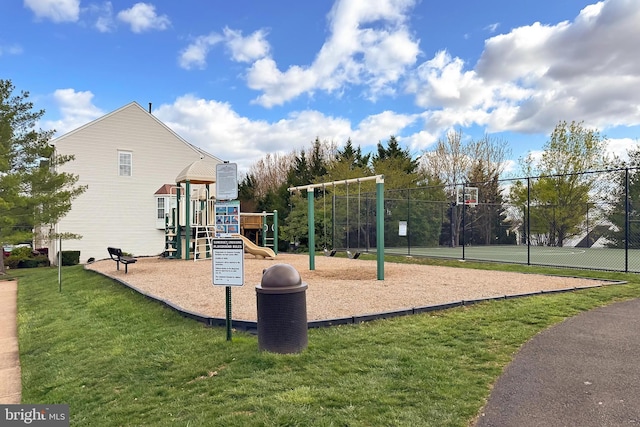 community jungle gym featuring a yard and fence