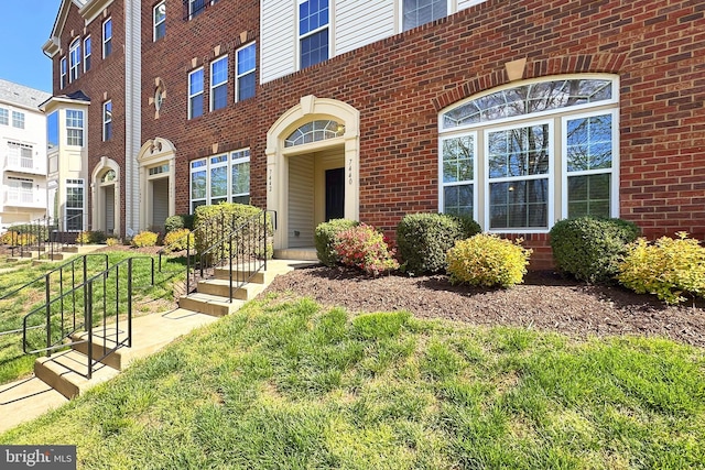 doorway to property with brick siding