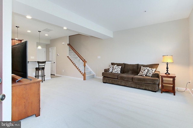 living room featuring recessed lighting, stairway, baseboards, and light carpet