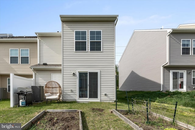 172 Scotch Pine Dr, Bunker Hill, WV 25413 - rear view of property with fence, a yard, central AC, and a vegetable garden