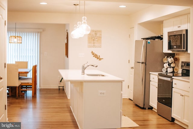 172 Scotch Pine Dr, Bunker Hill, WV 25413 - kitchen featuring appliances with stainless steel finishes, white cabinetry, light wood finished floors, and a sink