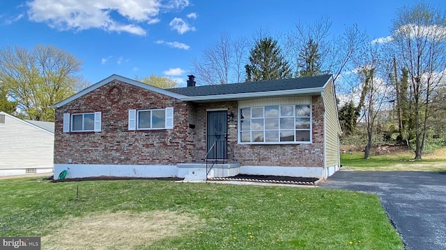 8107 Candle Ln, Baltimore, MD 21237 - view of front of house featuring brick siding, driveway, and a front yard