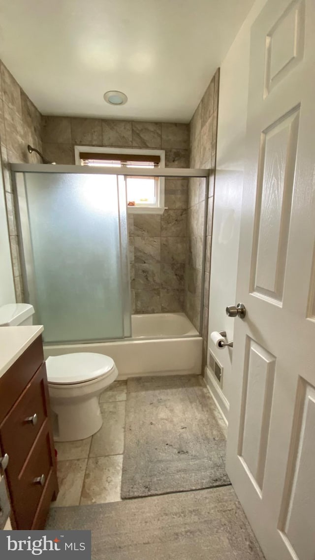 8107 Candle Ln, Baltimore, MD 21237 - bathroom with toilet, vanity, and shower / bath combination with glass door
