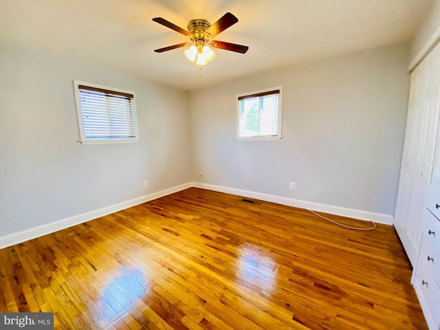 8107 Candle Ln, Baltimore, MD 21237 - unfurnished bedroom featuring a ceiling fan, hardwood / wood-style floors, a closet, baseboards, and visible vents