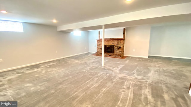 8107 Candle Ln, Baltimore, MD 21237 - below grade area featuring a fireplace, baseboards, and carpet