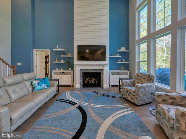 22144 Welches Way, Lewes, DE 19958 - living room with a high ceiling, a premium fireplace, wood finished floors, and stairs