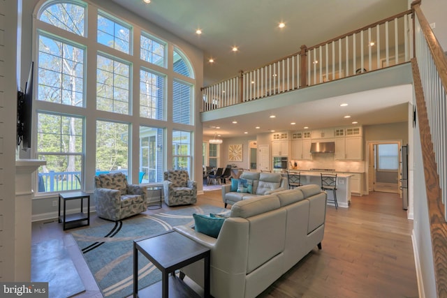 22144 Welches Way, Lewes, DE 19958 - living room featuring a towering ceiling, light wood-style flooring, recessed lighting, and baseboards