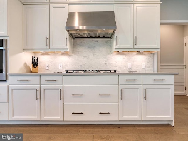 22144 Welches Way, Lewes, DE 19958 - kitchen featuring extractor fan, backsplash, gas stovetop, and white cabinets