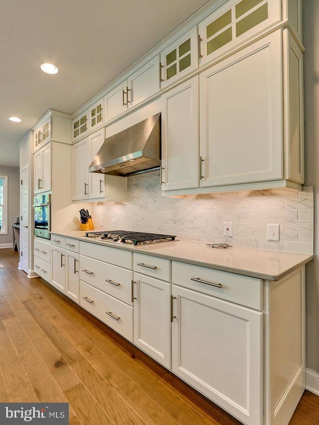 22144 Welches Way, Lewes, DE 19958 - kitchen featuring range hood, appliances with stainless steel finishes, recessed lighting, decorative backsplash, and light wood-type flooring