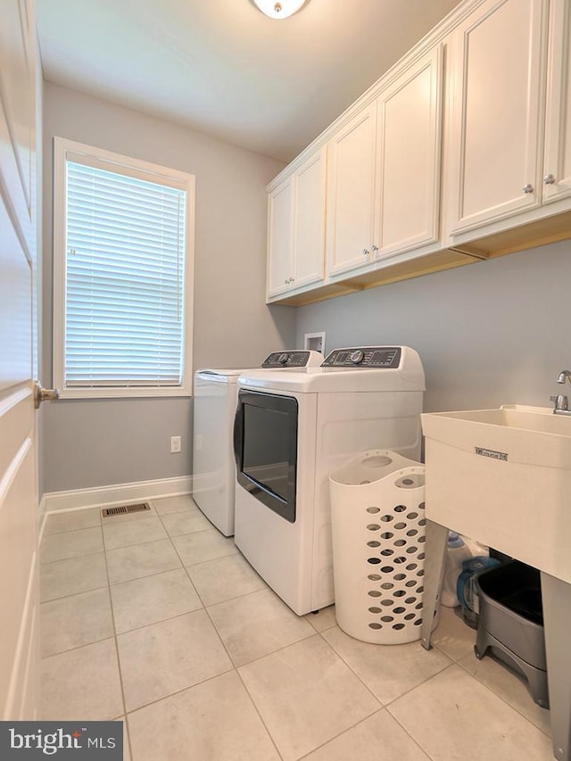 22144 Welches Way, Lewes, DE 19958 - laundry room with cabinet space, washer and dryer, light tile patterned floors, and baseboards