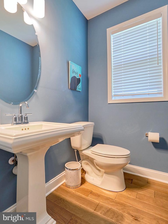 22144 Welches Way, Lewes, DE 19958 - half bathroom with wood finished floors, toilet, and baseboards