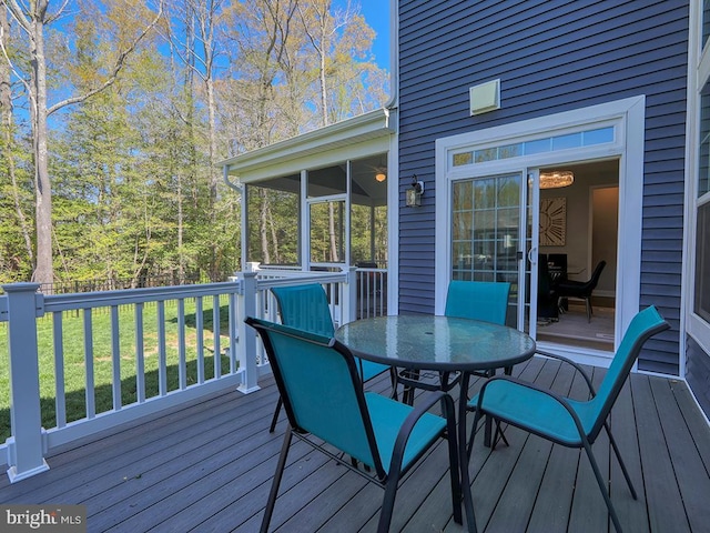 22144 Welches Way, Lewes, DE 19958 - deck with outdoor dining area, a sunroom, and a yard