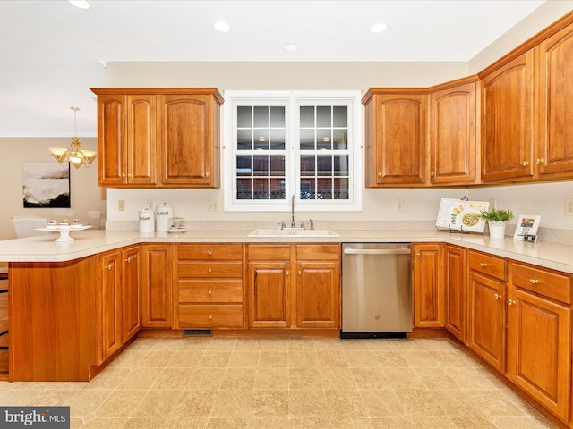 kitchen featuring a peninsula, dishwasher, a sink, and brown cabinets