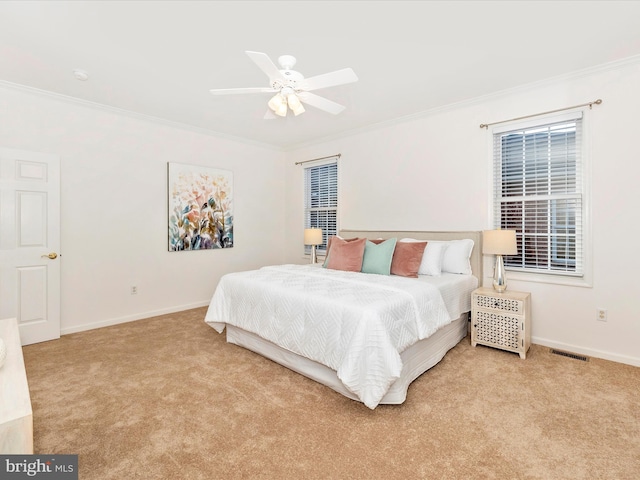 bedroom featuring visible vents, light carpet, baseboards, and ornamental molding