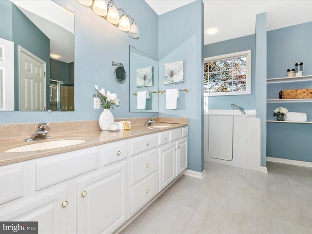 full bathroom featuring a garden tub, a sink, a shower stall, and double vanity