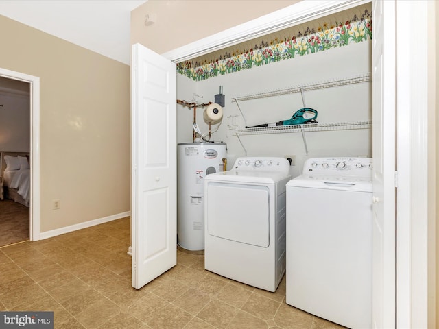 washroom featuring baseboards, separate washer and dryer, laundry area, and electric water heater